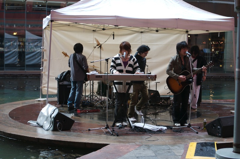 A band prepares to start a show in the middle of the stadium area; we went down to the bottom to see.