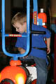Mark riding a helicopter ride at Chuck E. Cheese (50mm, f/4.5, 1/60 sec, built-in flash)
